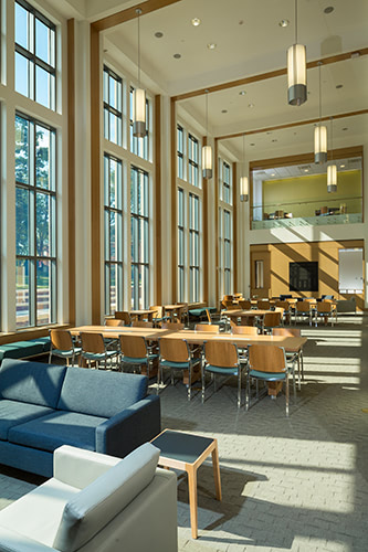 Interior of a workspace with large windows on the left.