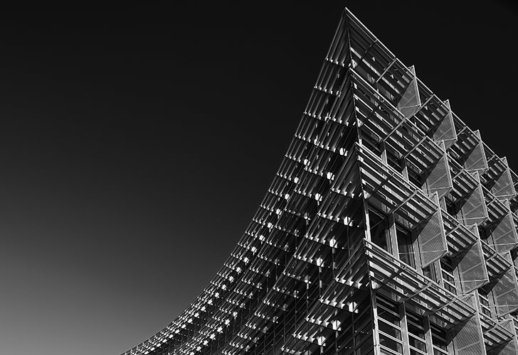 Black and white image of the corner of the Alcoa building.