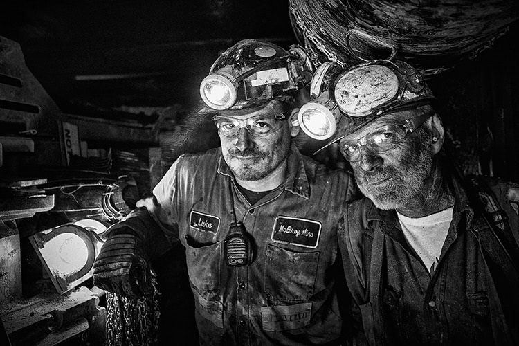 Black and white photo of two miners in a mine.